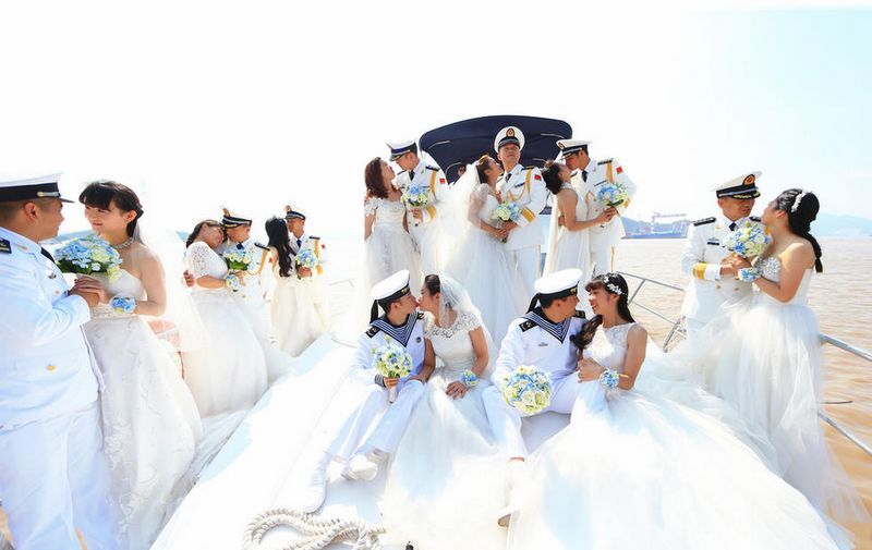 集体婚礼上，新人们在快艇上拍合影，一对对新人爱意浓浓。