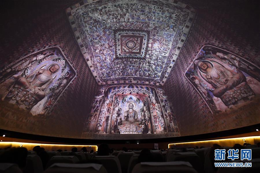 游客在敦煌莫高窟数字展示中心欣赏球幕电影《梦幻佛宫》(4月15日摄).