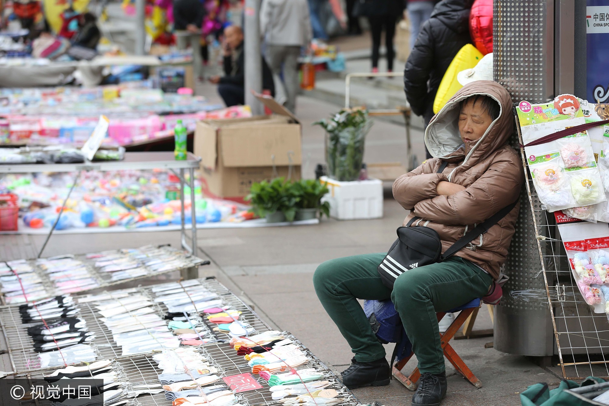 穿棉衣守摊。